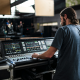 man working sound board for event production services