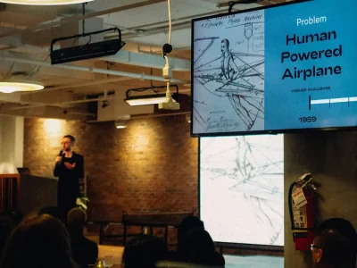 a man standing in front of a screen making presentation production services